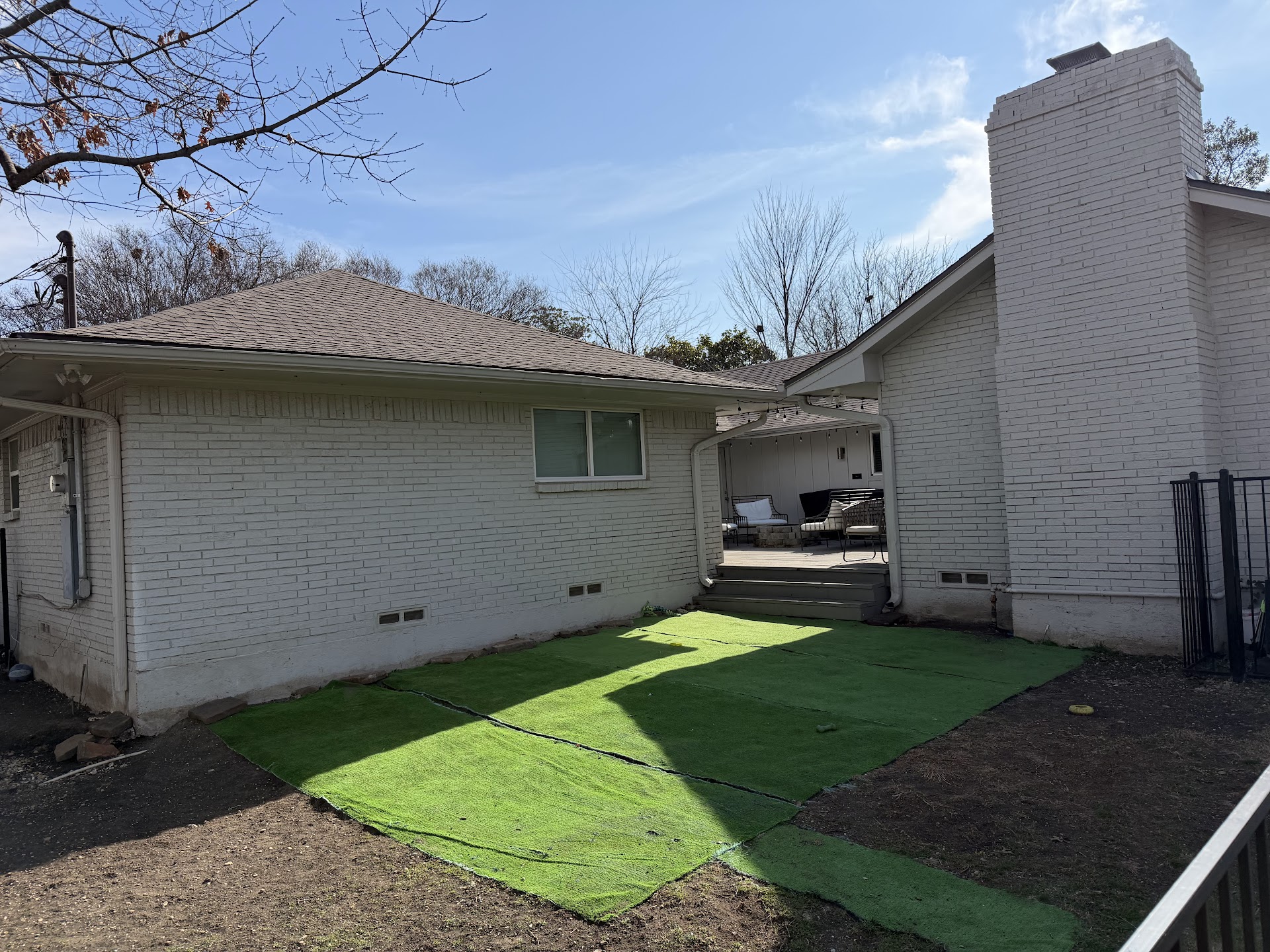 Backyard renovation with fresh turf installation
