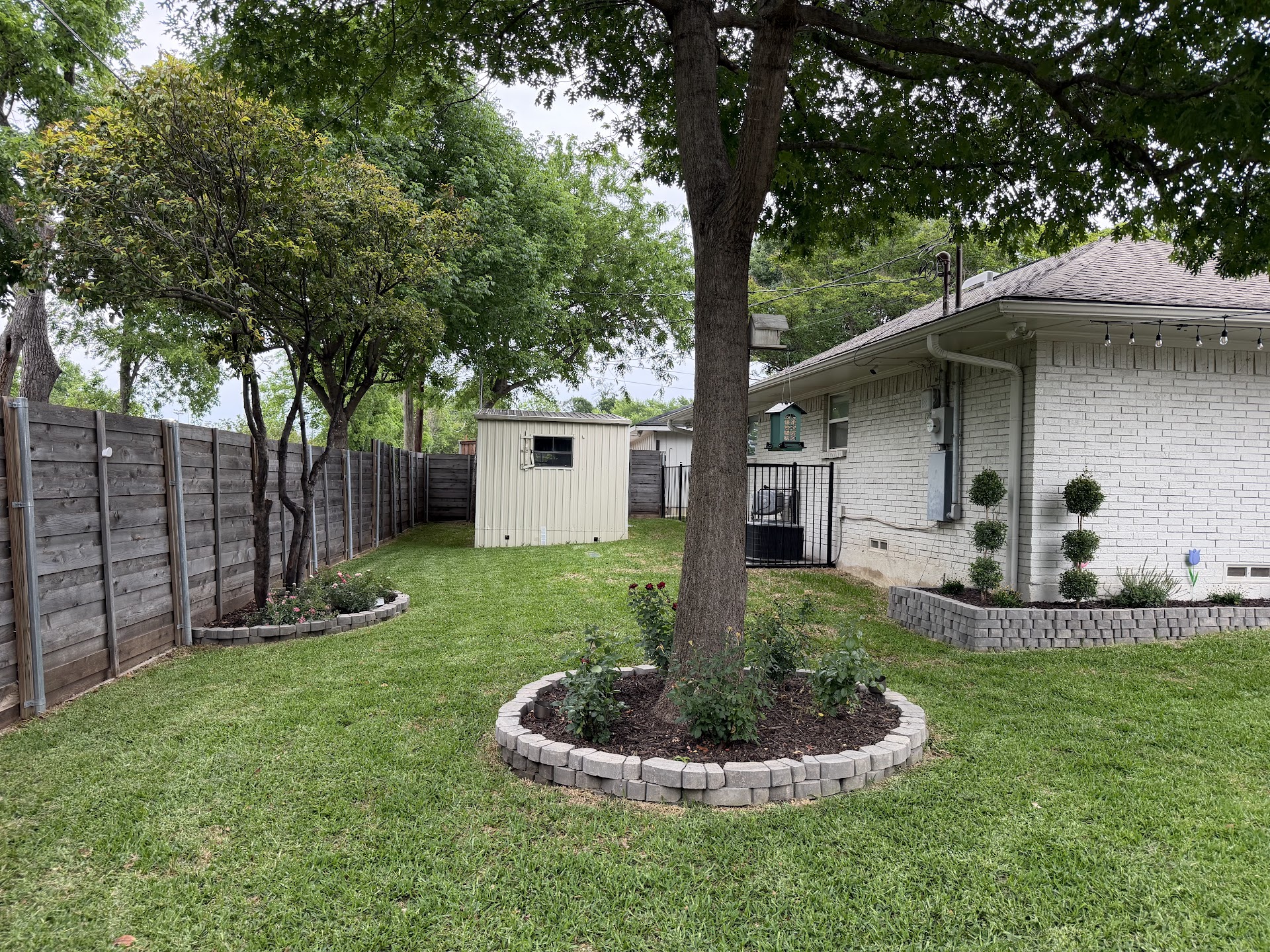 Landscaped backyard with stone planting beds